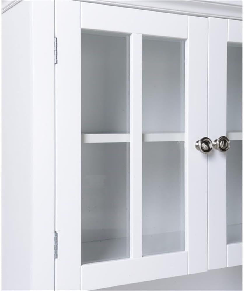 Close-up of two upper glass cabinet doors with vertical muntins and two round knobs.