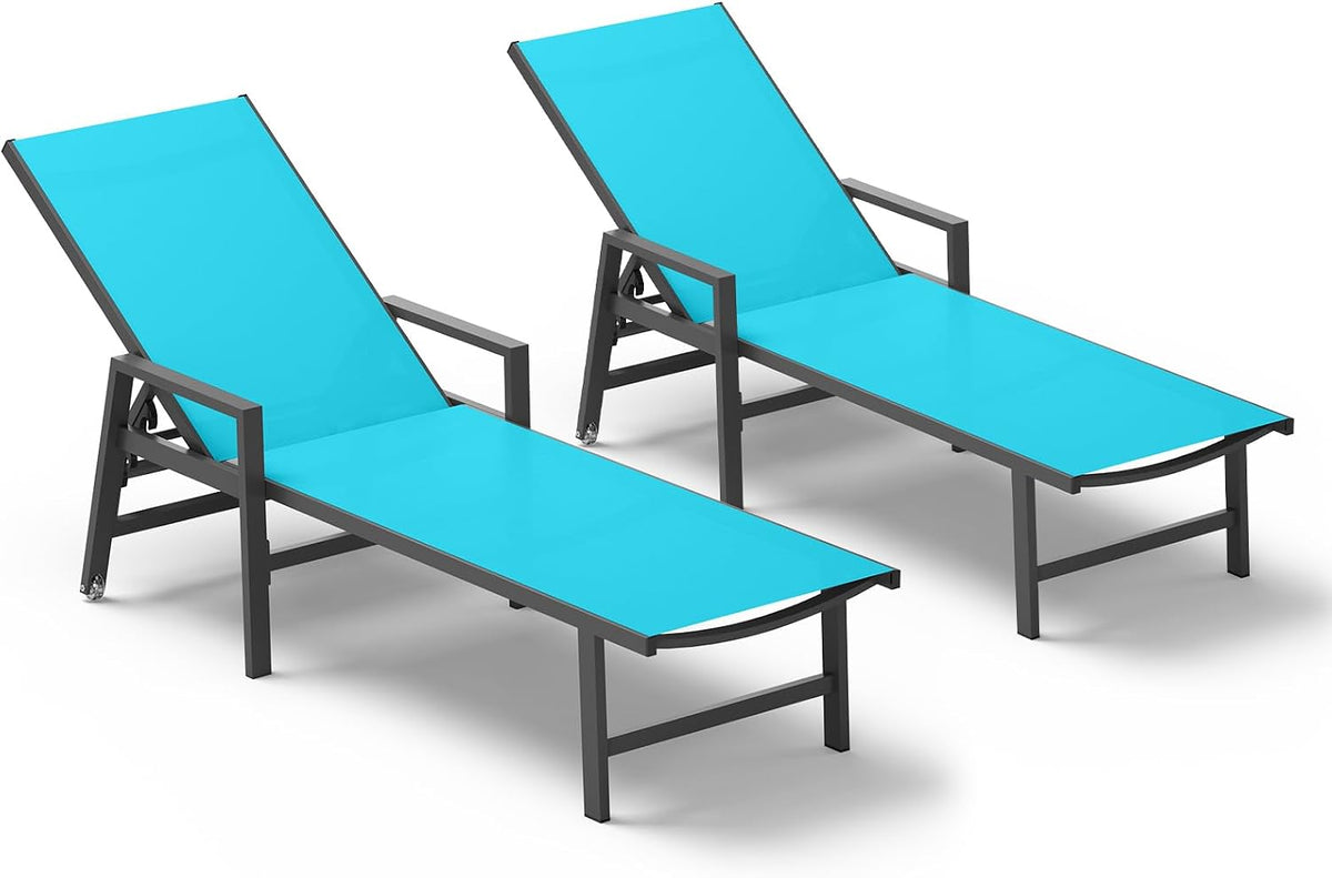 Two turquoise chaise lounges arranged in a staggered pair from an elevated angle
