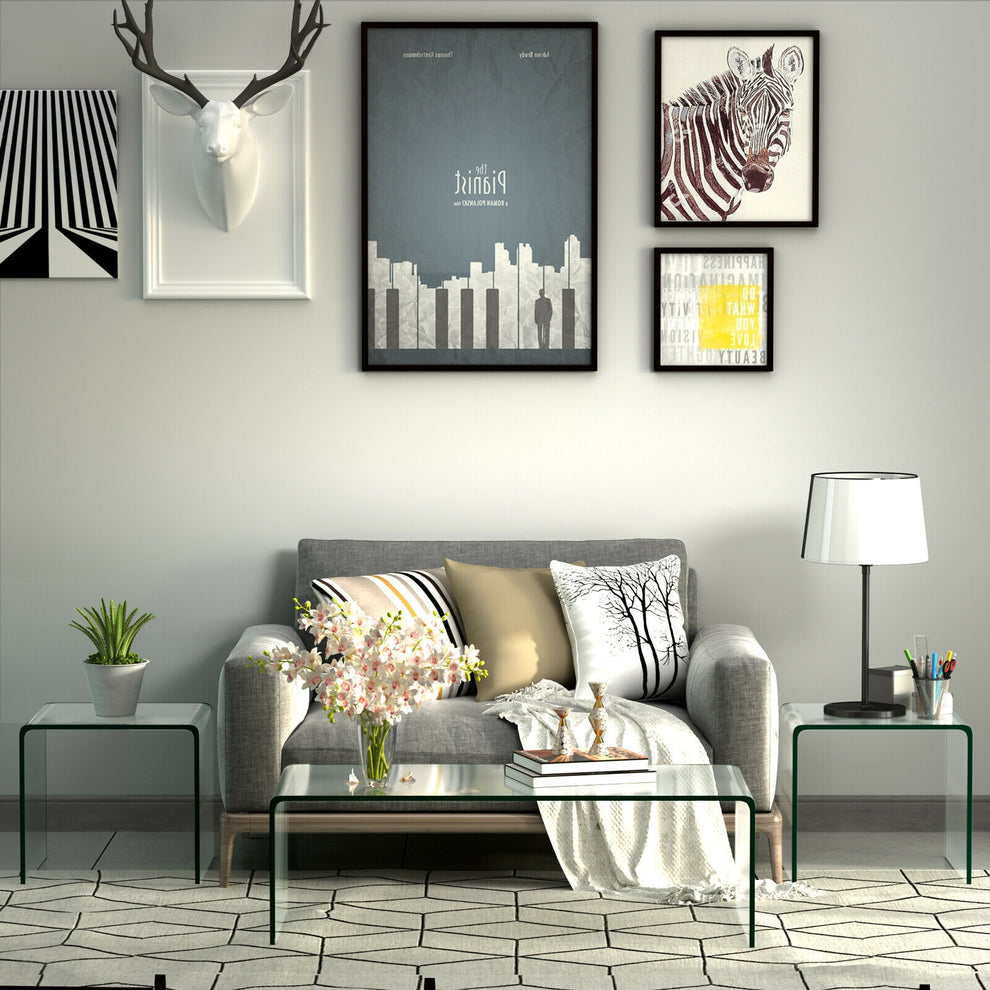 Transparent glass end table beside a sofa in a staged living room