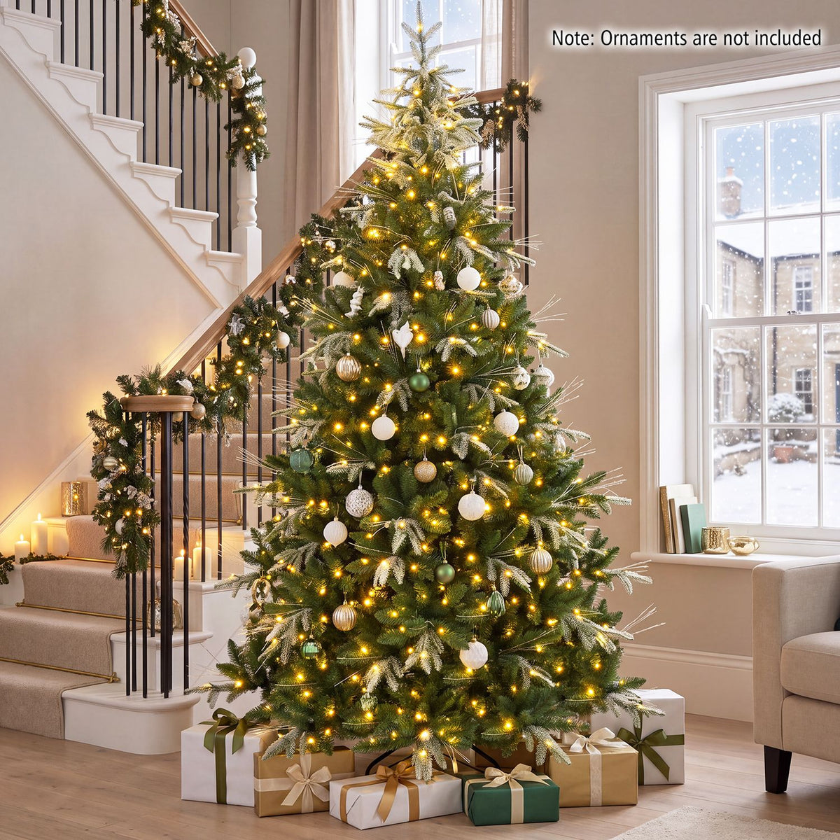 A glowing decorated Christmas tree stands beside a staircase, with wrapped gifts beneath it.