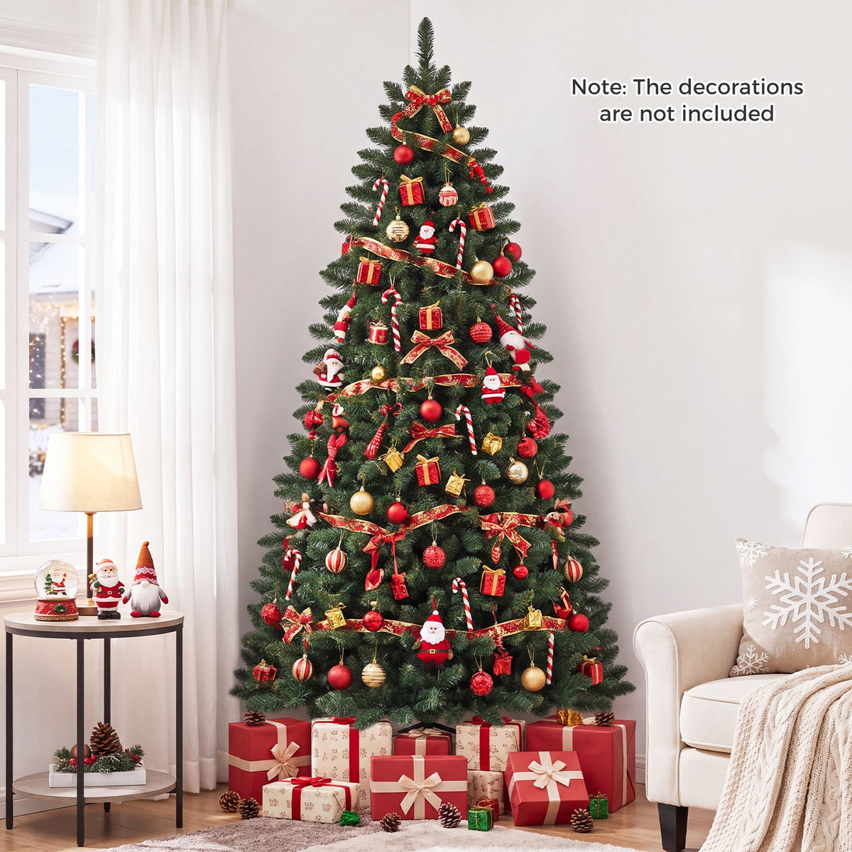 Decorated green Christmas tree beside a window, with wrapped presents and a cream armchair nearby.