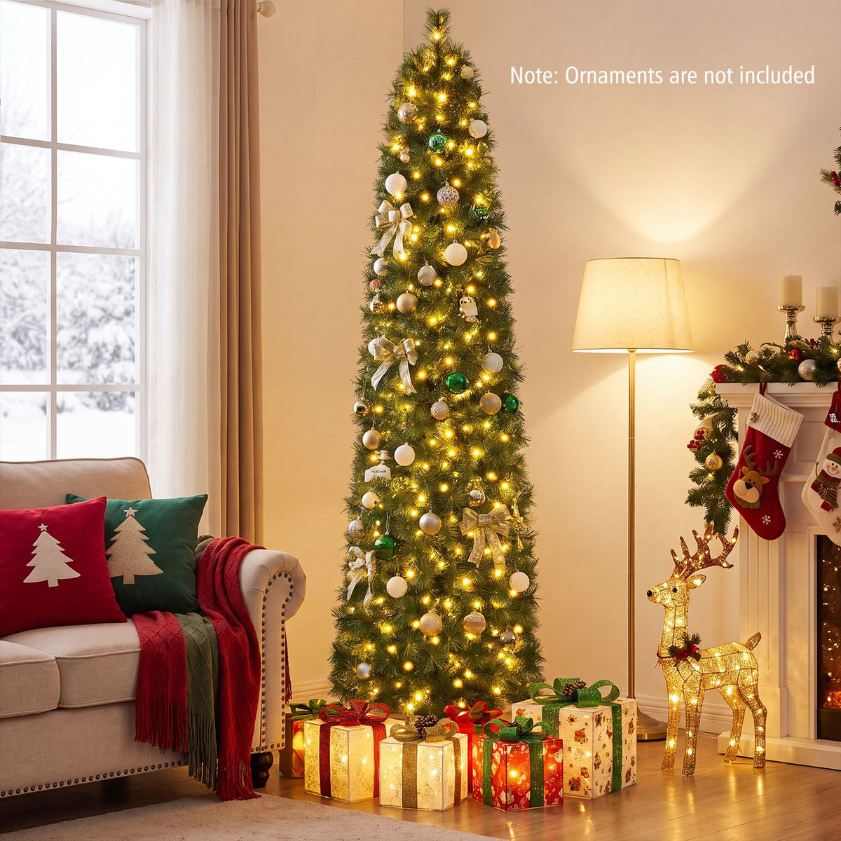 A lit, decorated Christmas tree stands beside a sofa and fireplace, with wrapped gifts beneath it.