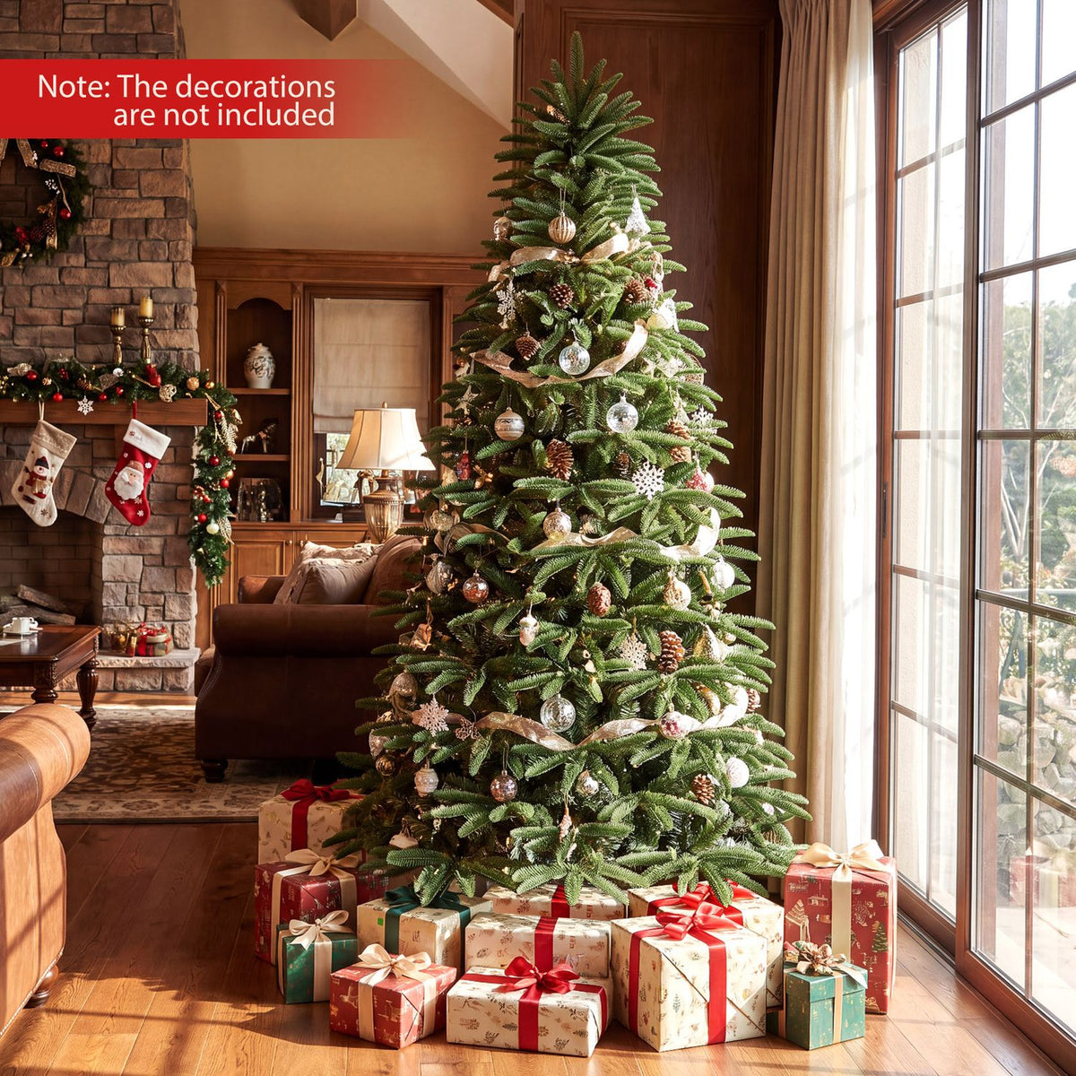 Decorated Christmas tree surrounded by wrapped gifts in a warm living room beside tall windows.