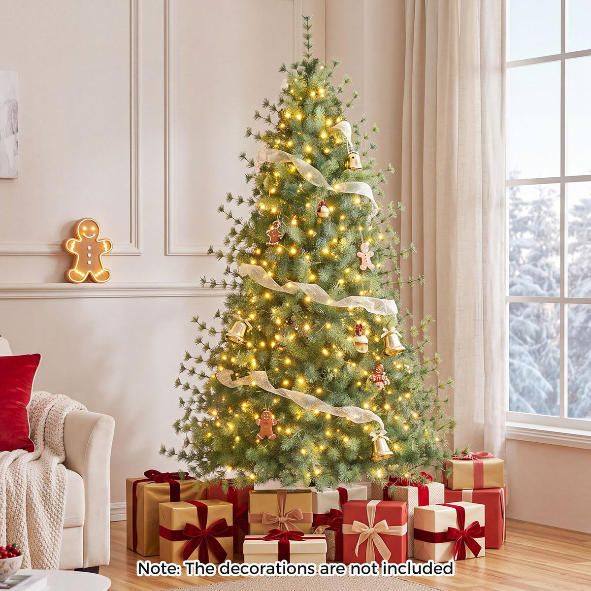 Decorated artificial Christmas tree glowing with warm lights beside a sofa, with wrapped gifts beneath it.