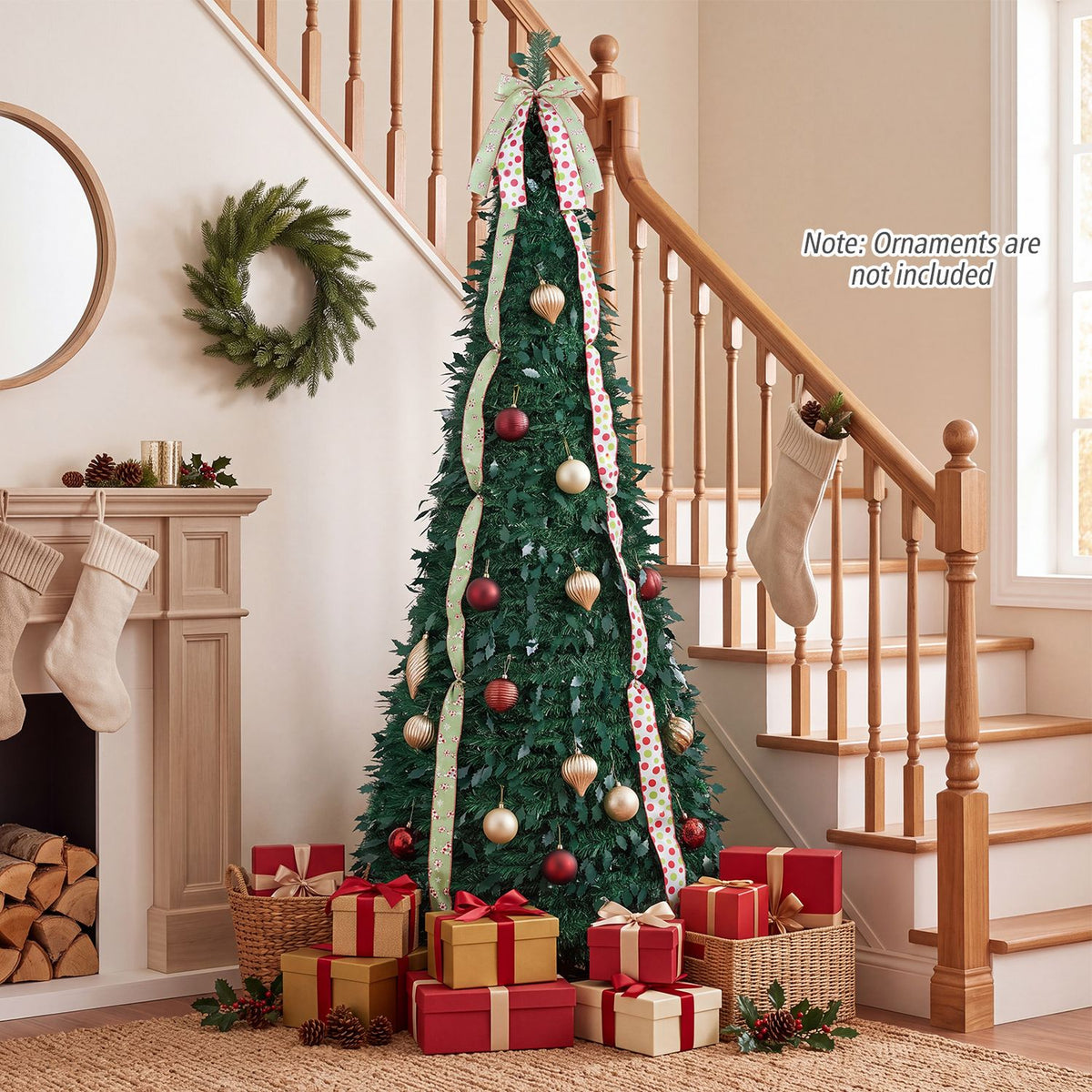 Green Christmas tree with patterned ribbons, red and gold ornaments, and wrapped presents at its base beside a staircase.