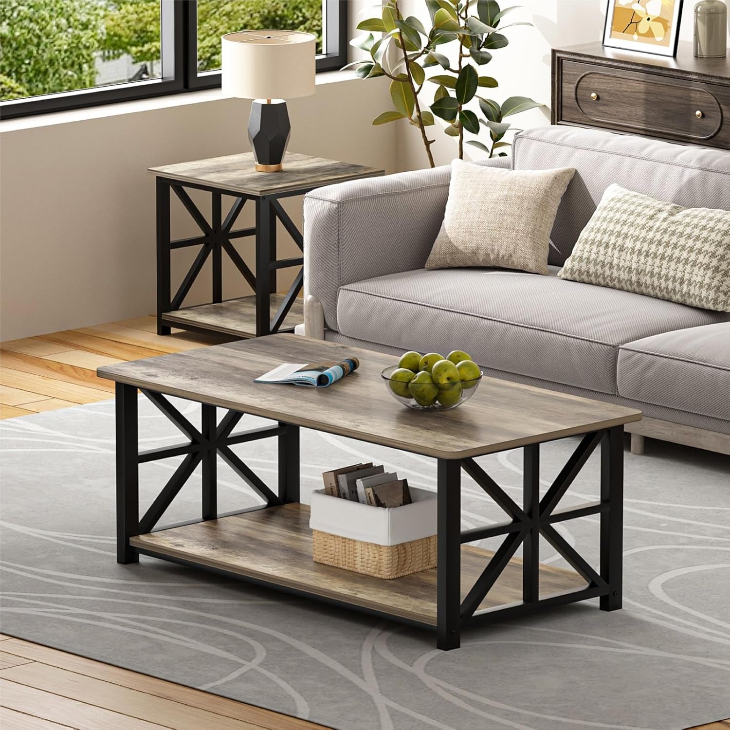 Living room scene with the coffee table in front of a gray sofa, bowl of apples on top and matching side table beside a