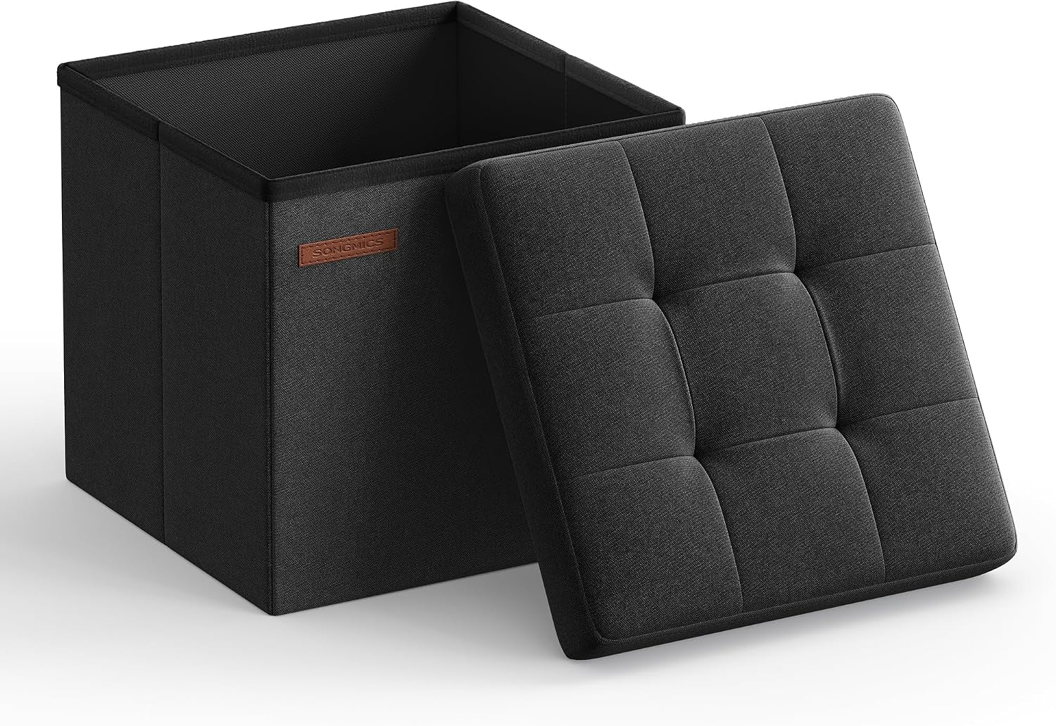 Open black square storage ottoman with tufted padded lid propped against the box