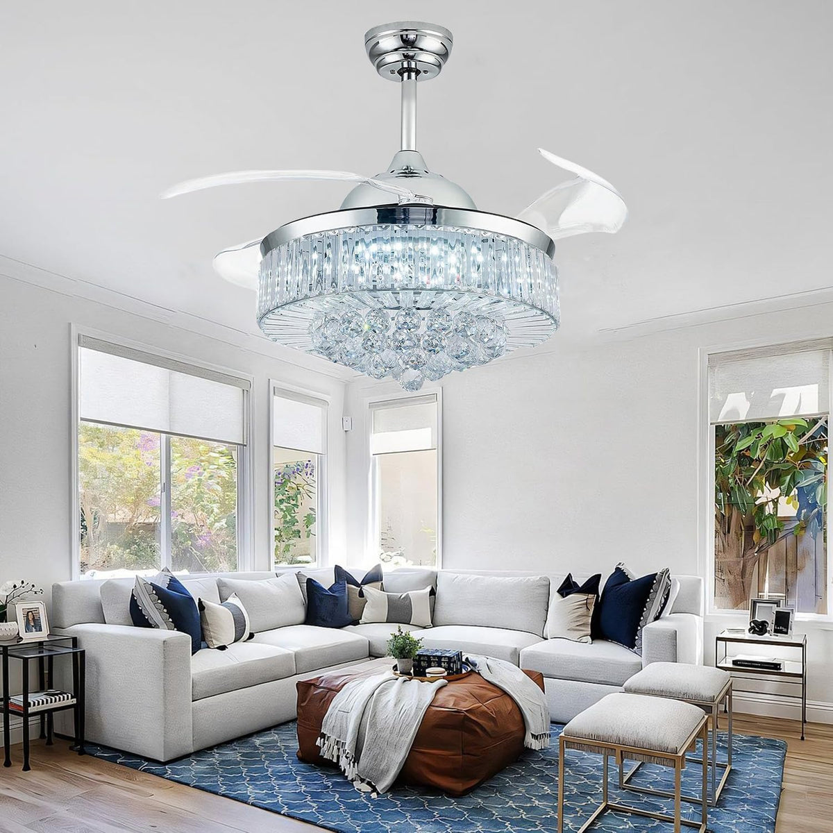 Wide-angle living room scene with chrome crystal fandelier installed above a sectional sofa.