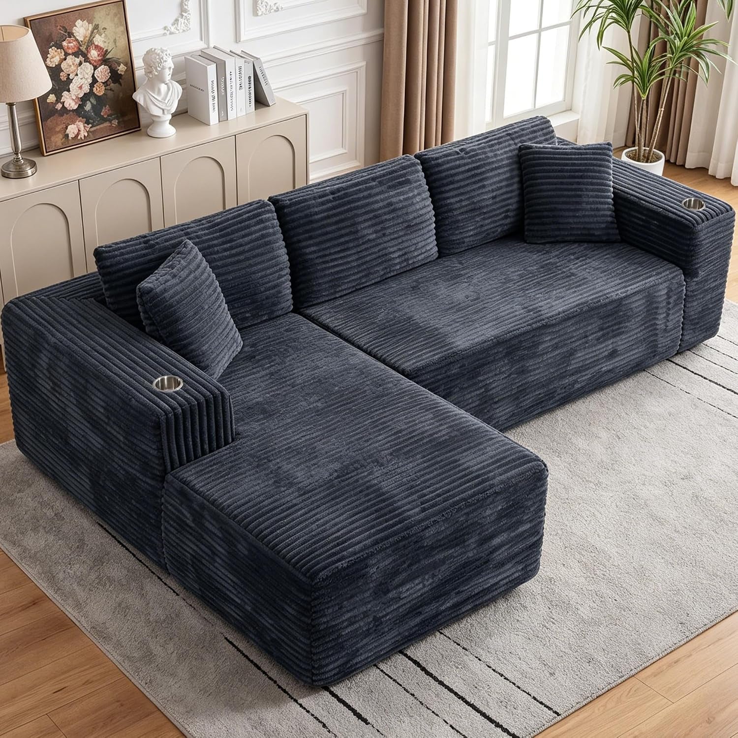 Angled overhead view of a charcoal corduroy modular sectional with oversized chaise on a rug.