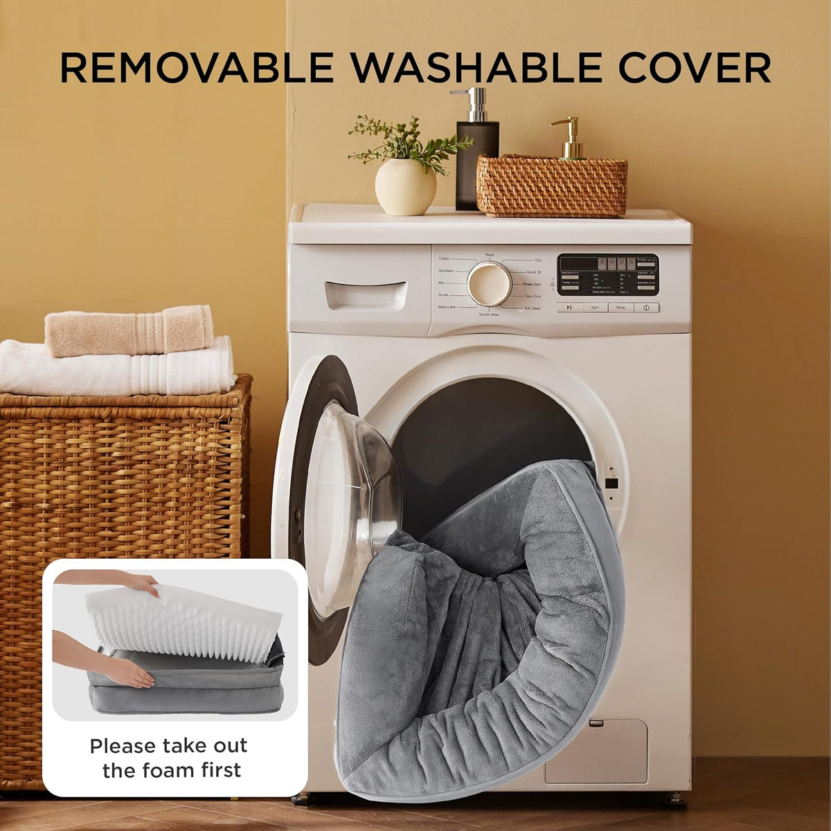 Removable grey bed cover being placed into a front‑loading washing machine with foam removed