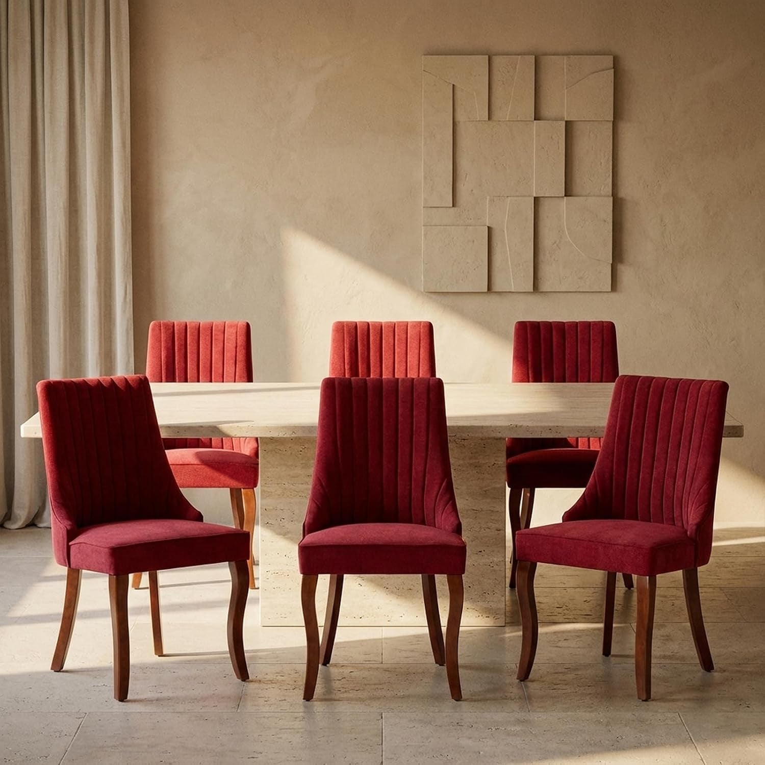 Six red upholstered dining chairs with vertical channel tufting around a rectangular stone table.