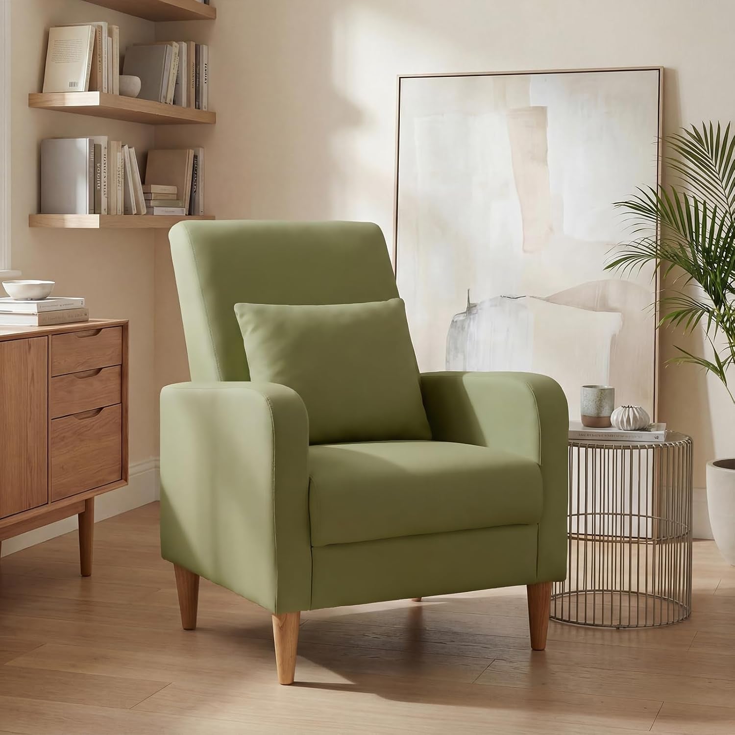 Single light green upholstered accent chair with pillow in a sunlit living corner