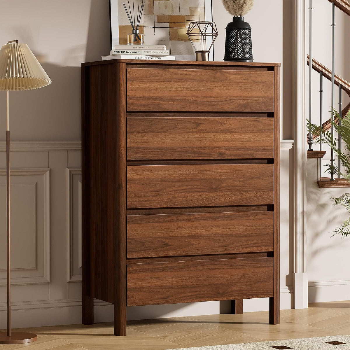 Walnut tall chest placed by a staircase with lamp and decor on top in a staged interior