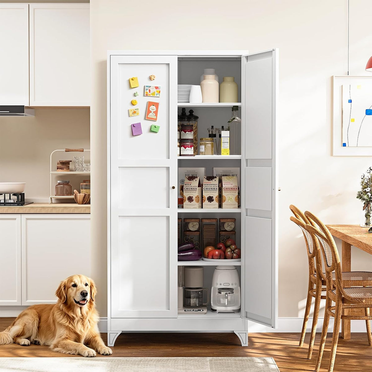White pantry cabinet with one door open showing organized pantry items, placed between kitchen and dining chairs.