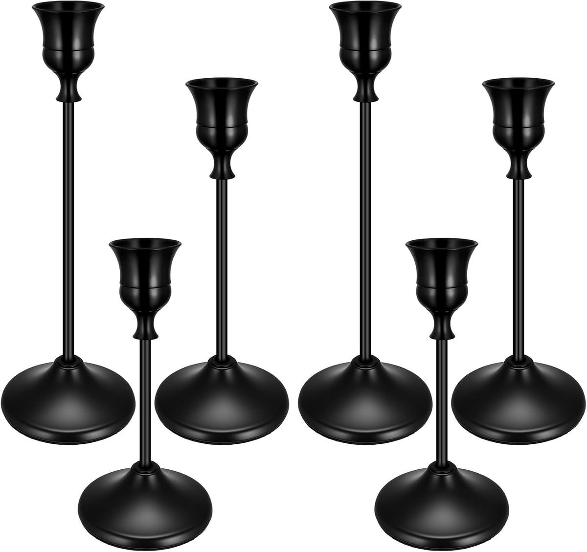 Close grouping of five black metal taper candlesticks shown at different heights on white background