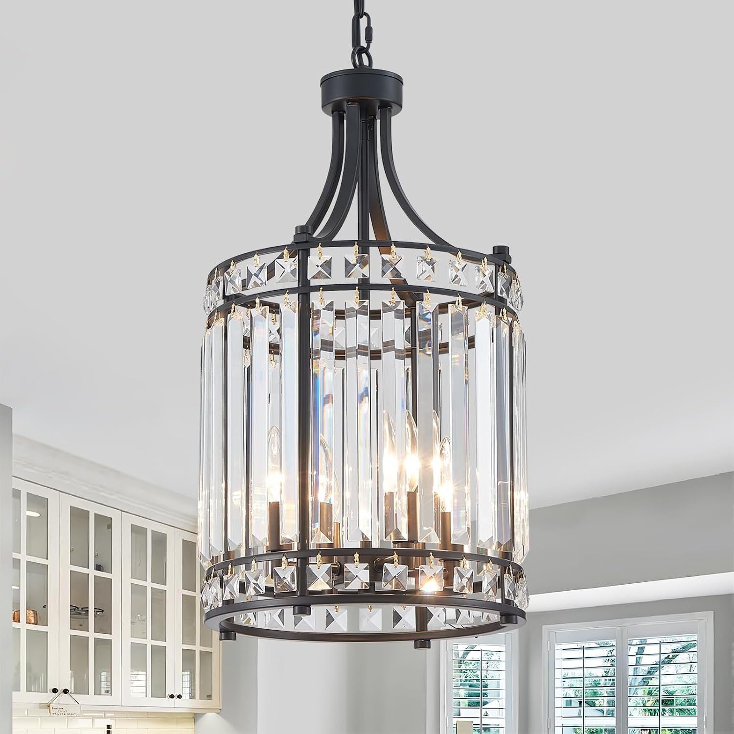 Black all-metal pendant chandelier with vertical K9 crystal prisms, angled close-up in a kitchen