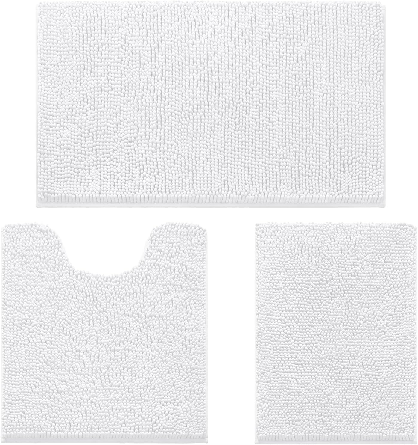 Flat lay of three white chenille bathroom rugs: large bath mat, U-shaped contour mat, and small rectangular mat