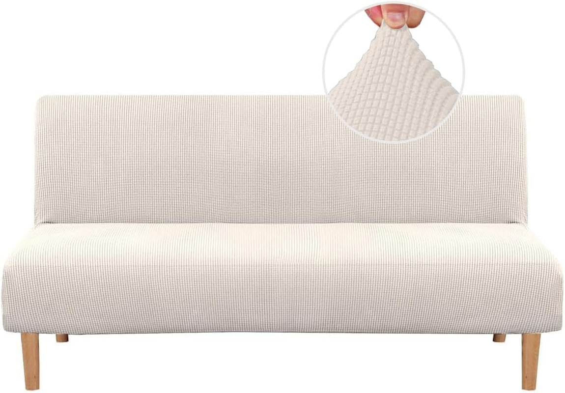 Frontal shot of a futon wearing an off-white small-check slipcover, showing wood legs and fabric texture