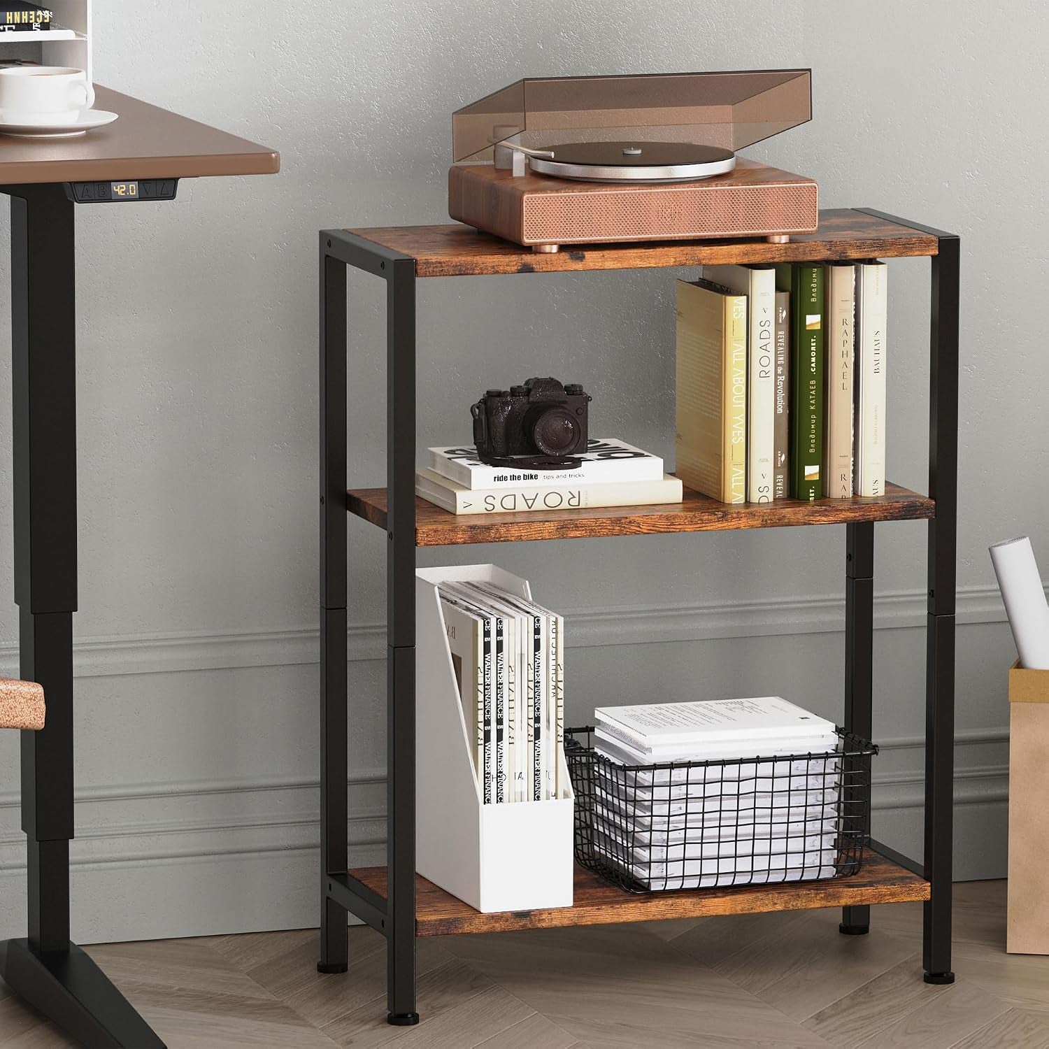 Three-tier side table shown in an office setting with books and storage basket on the shelves