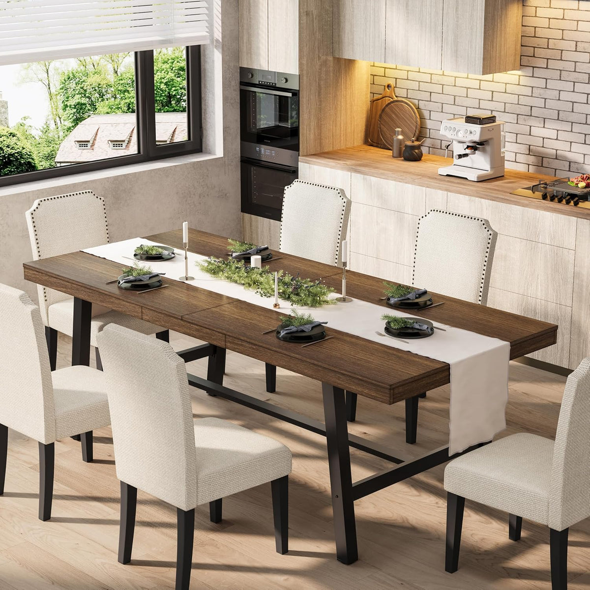 Angled view of the extendable table showing the butterfly leaf seam and upholstered dining chairs around it.