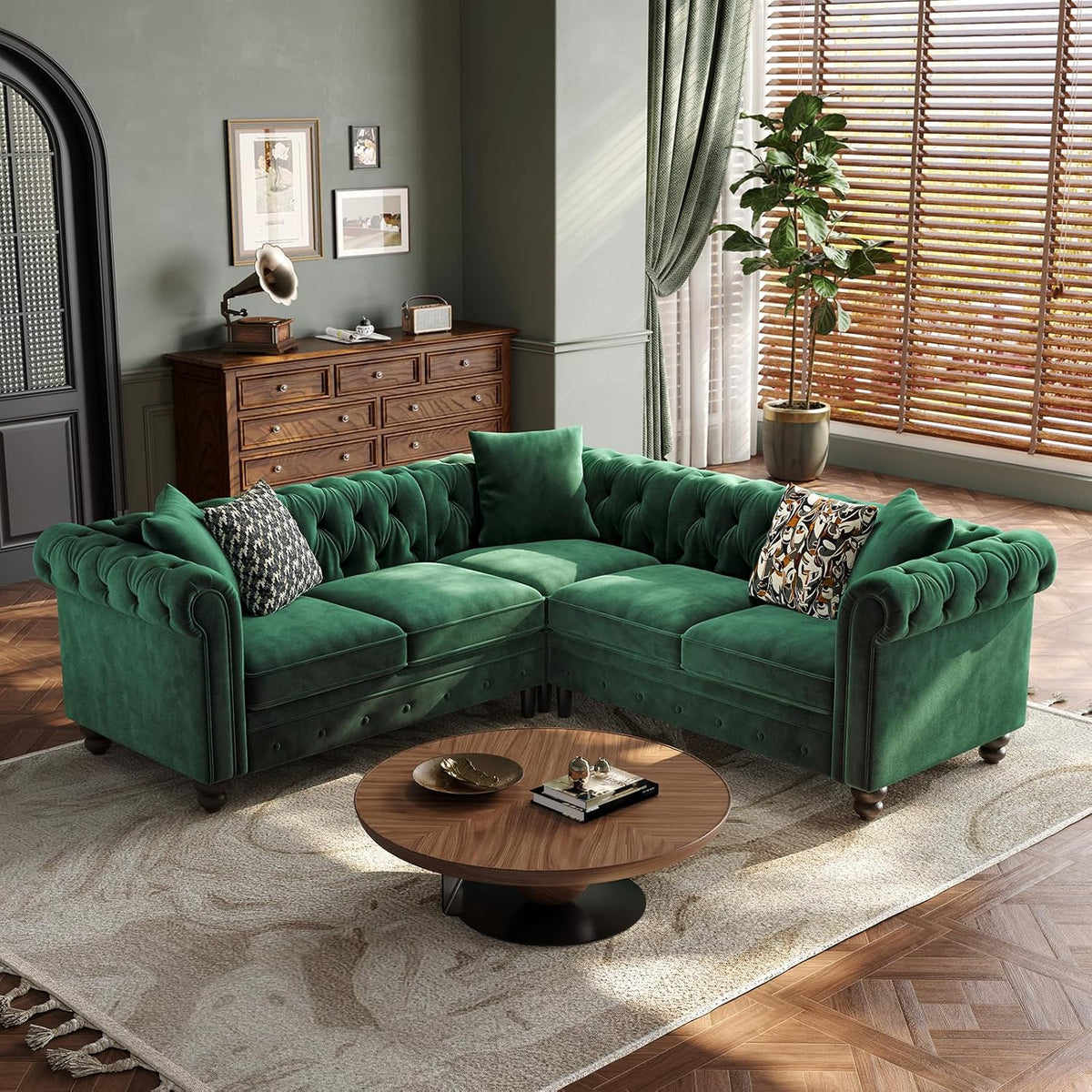 Green velvet L-shaped Chesterfield sectional angled front view with tufted back and coffee table