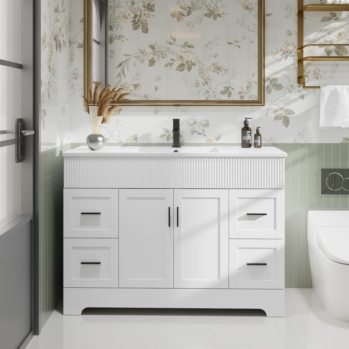 White single-sink vanity with vertical ribbed apron and black hardware in bright bathroom