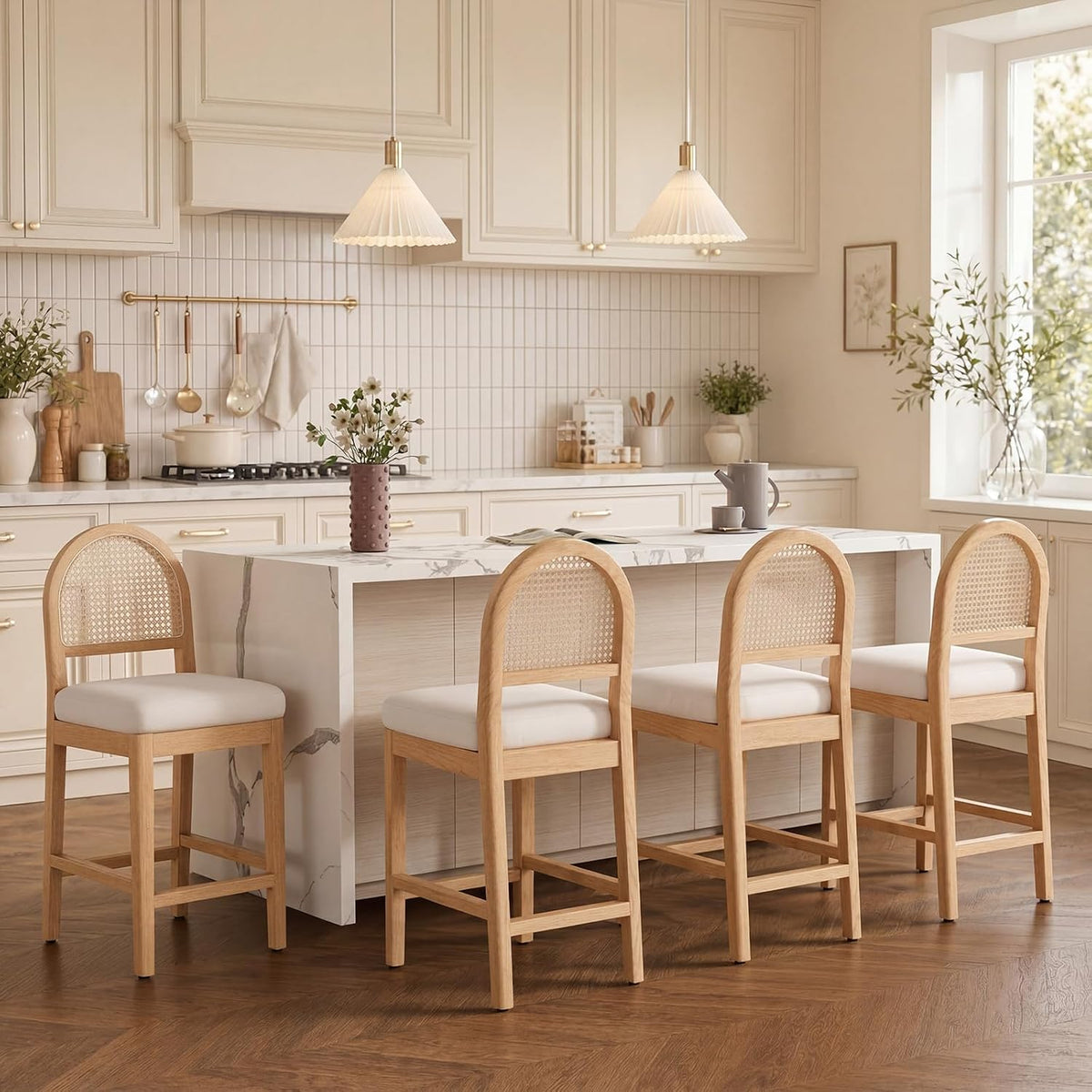 Four light-wood rattan-back counter stools along a kitchen island seen from behind