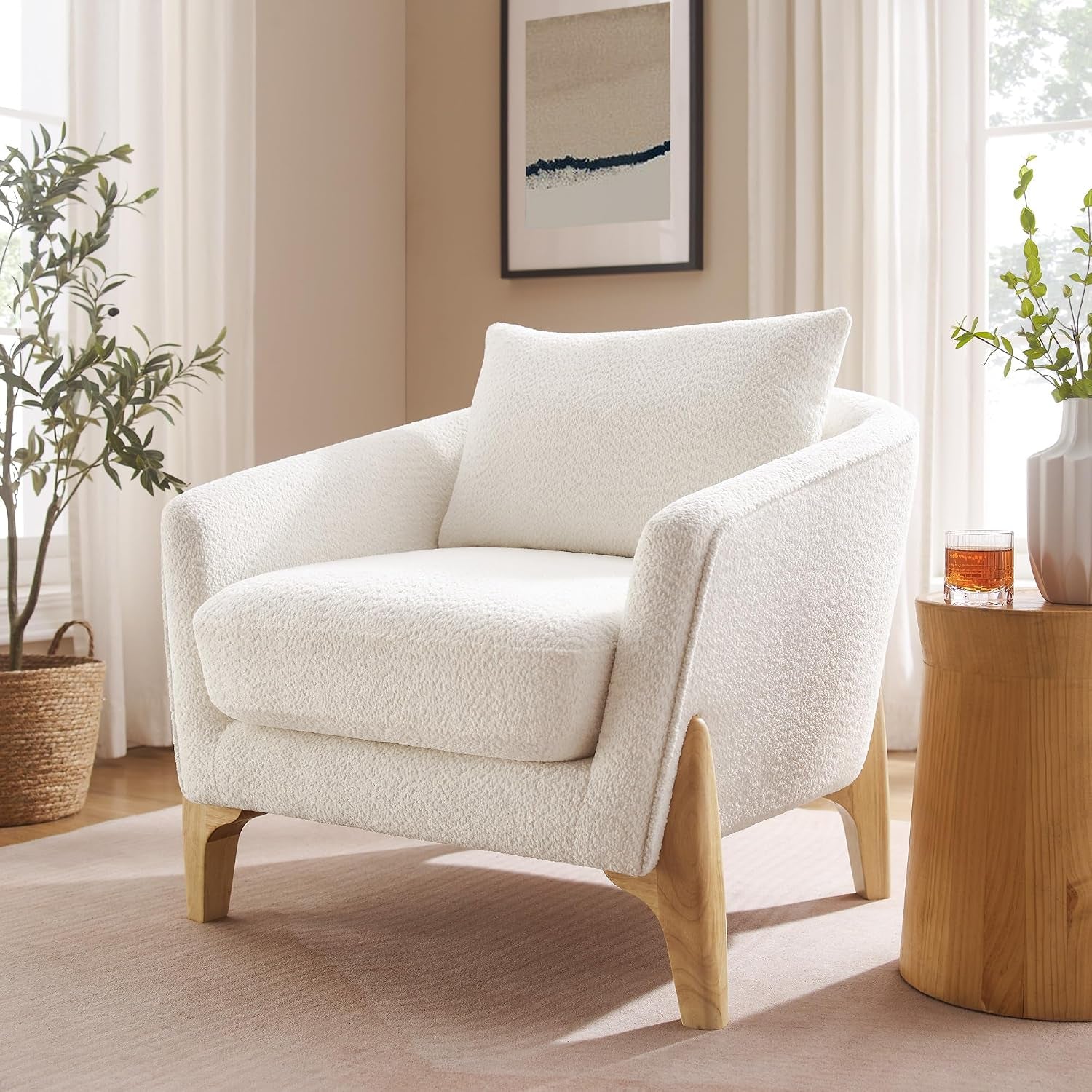 White fleece oversized accent chair angled front-left view with visible wood legs in a living room