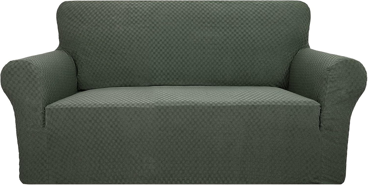 Front view of a dark green textured stretch sofa cover on a two-seat couch