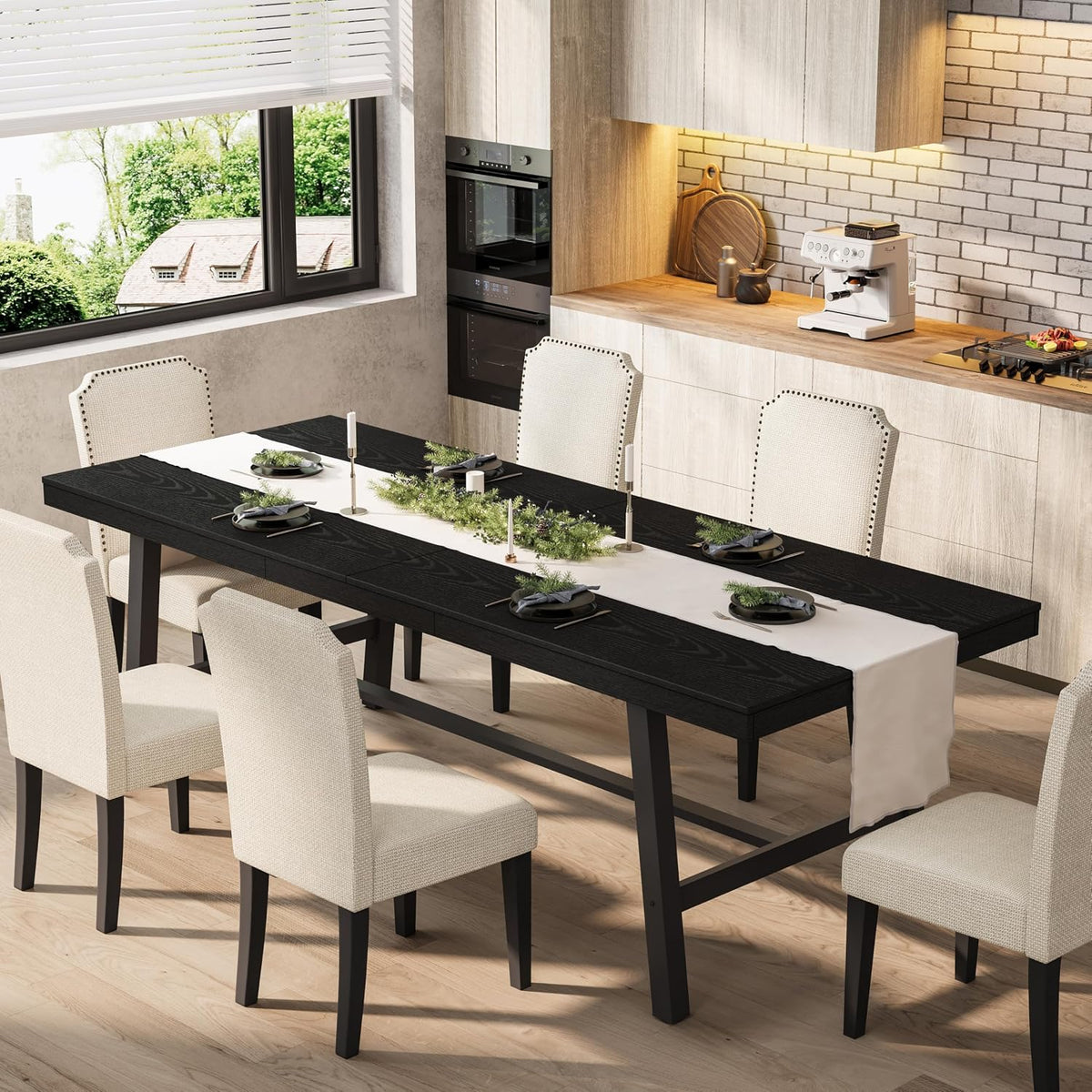 Dining scene showing the long black table set with a white runner, candles and six beige upholstered chairs.
