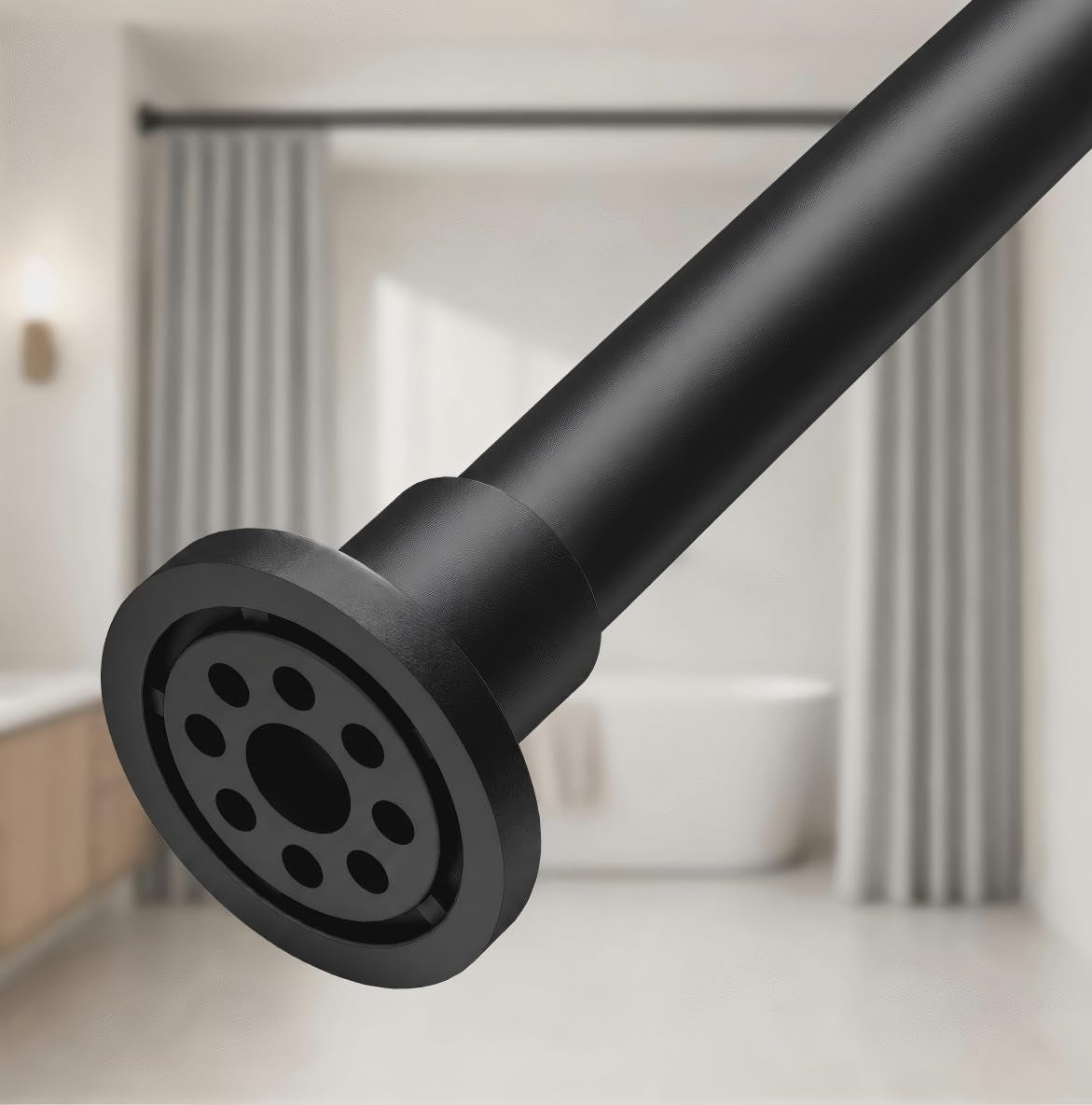 Black rod end shown front-facing to reveal circular multi-hole rubber contact pad and textured rim