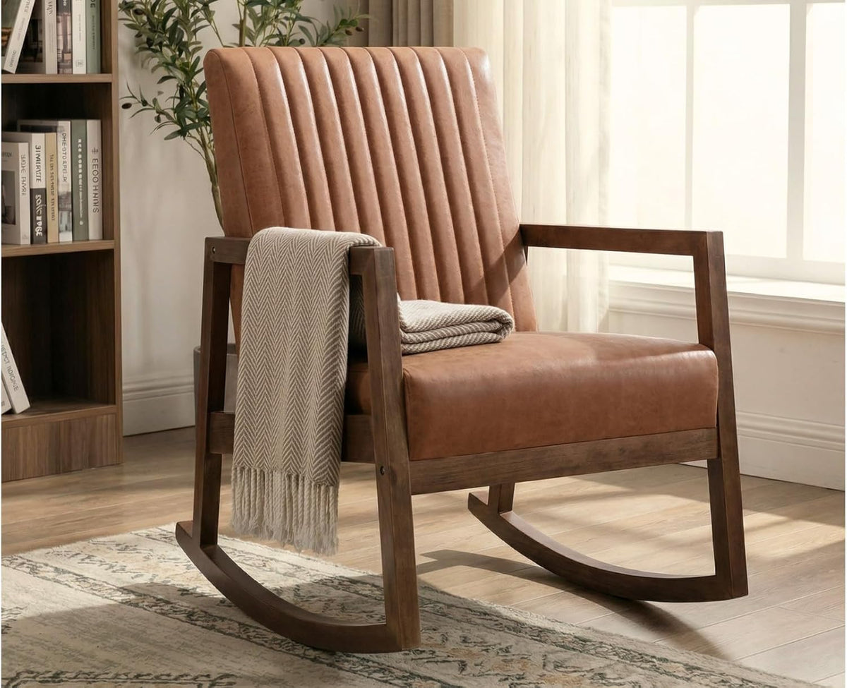 Angled view of a tan faux-leather rocking chair with vertical channel tufting and dark wooden rockers.