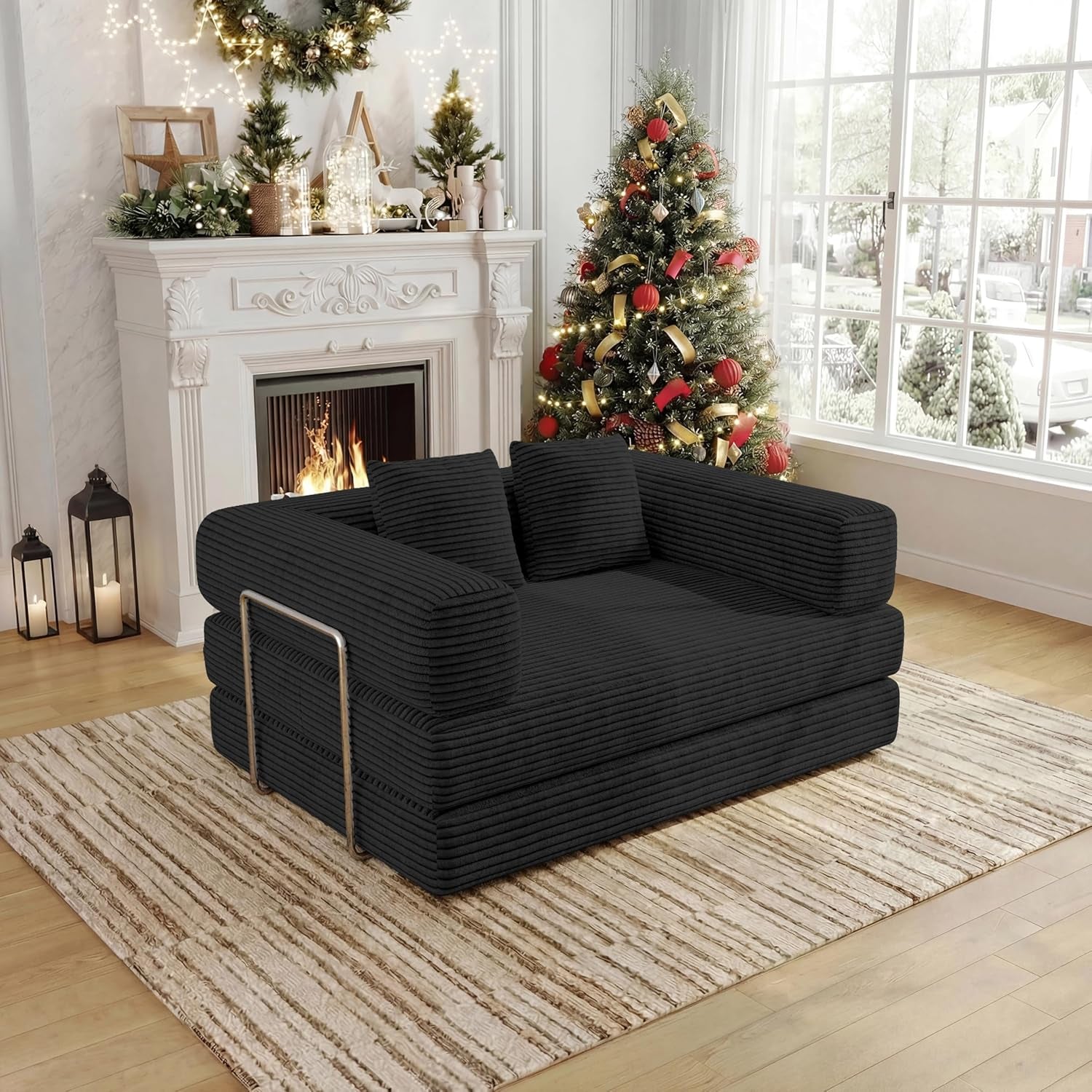 Angled side view of the black corduroy convertible sofa showing stacked cushion arms and metal support.