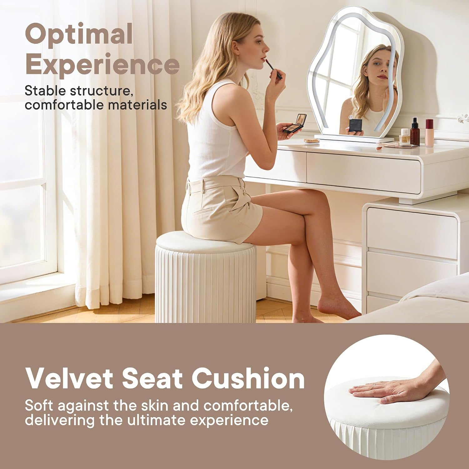 Woman sitting on a beige velvet ottoman used as a vanity stool in a bedroom setting