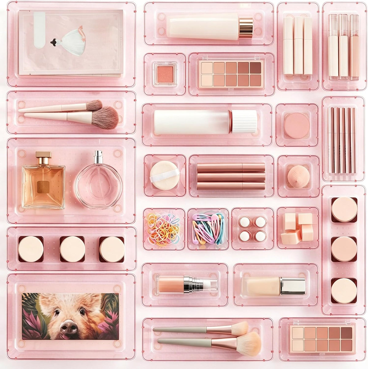 Top view of translucent rose-pink trays arranged with cosmetics and a pig illustration