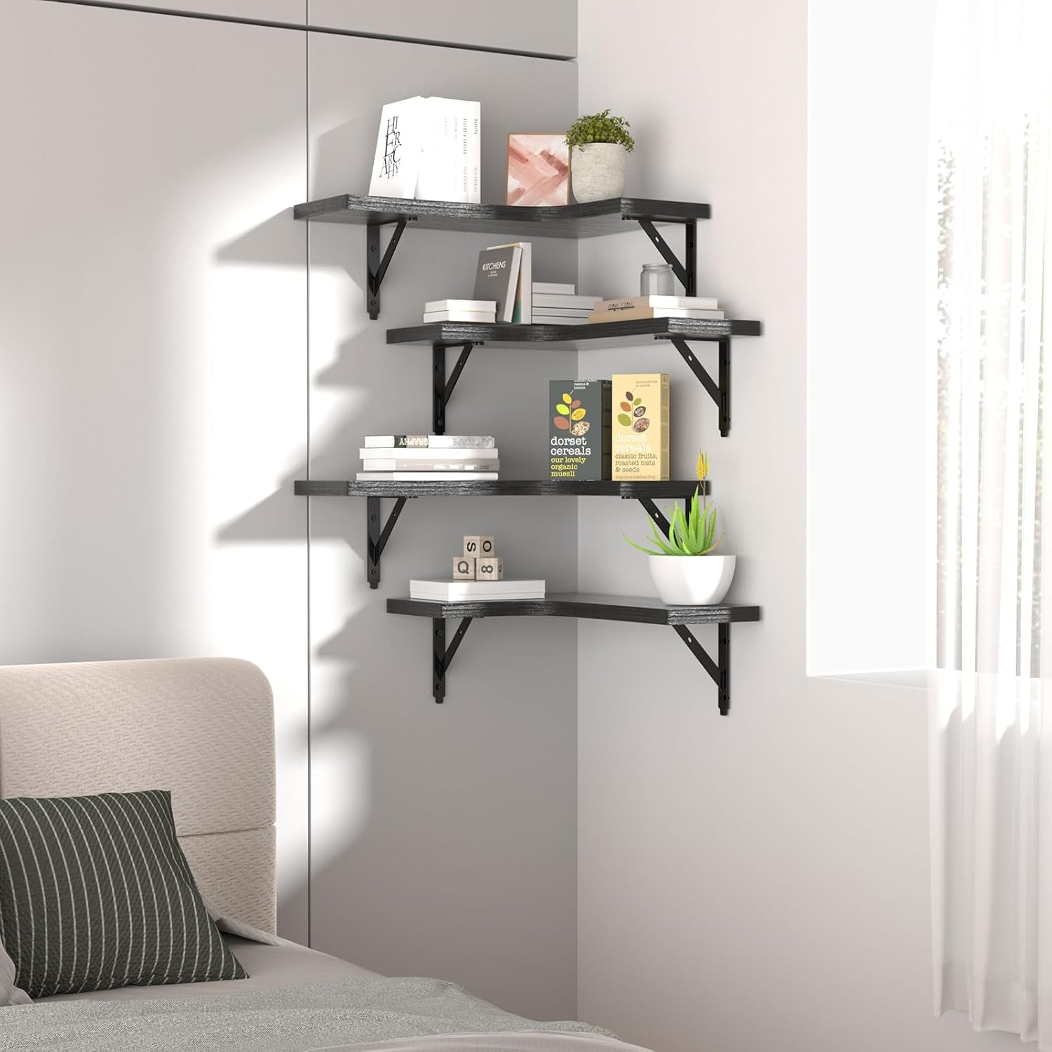 Bedroom corner with four black L-shaped floating shelves holding books and plants.