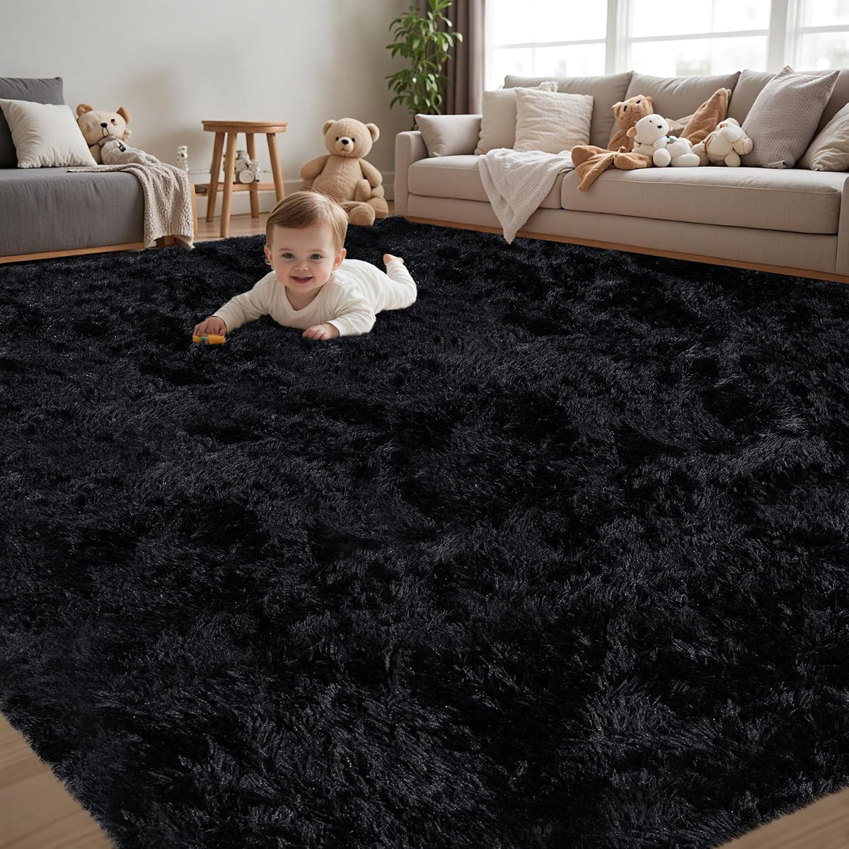 Baby crawling on a large black fluffy shag rug in a living room with beige sofas and teddy bears.