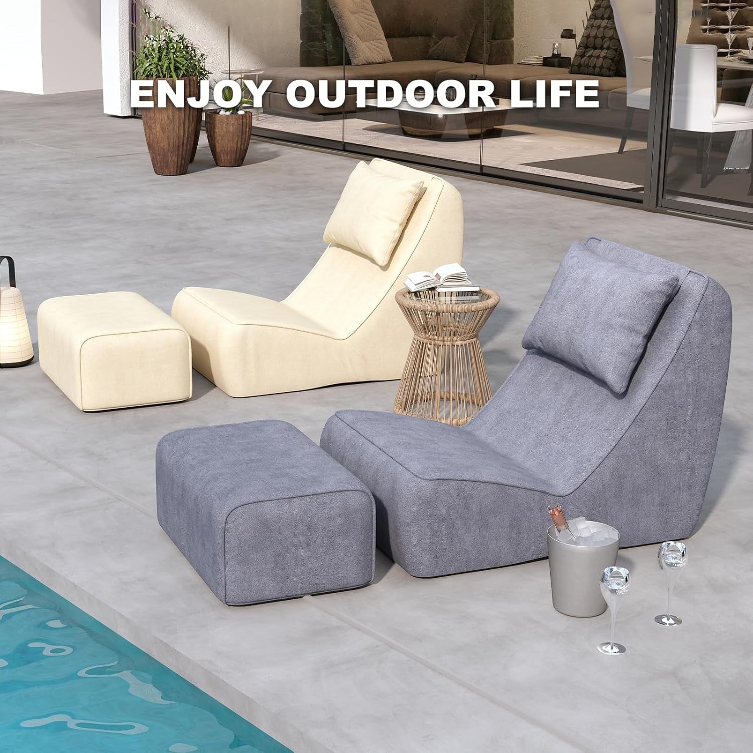 Poolside scene with a gray chaise and a cream chaise paired with ottomans on a stone deck.