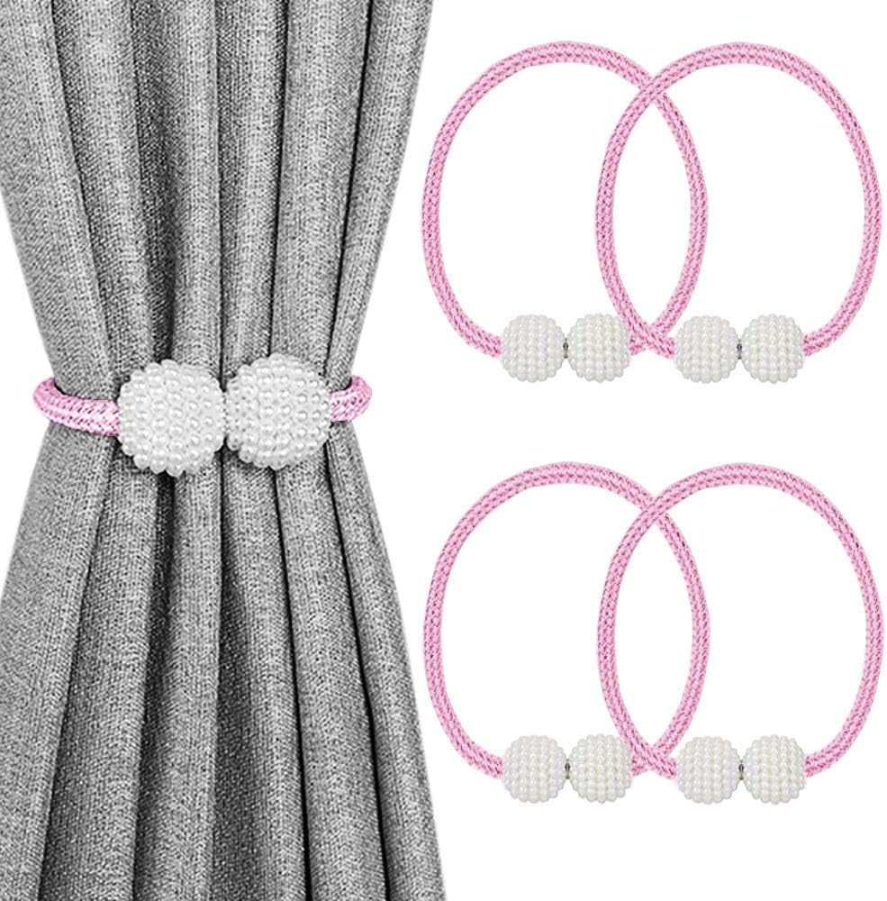 Pink braided magnetic curtain tiebacks with white beaded balls shown on gray curtain and as two spare pairs