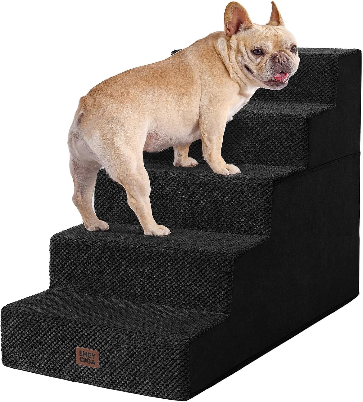 Front three-quarter shot of black textured four-step stairs with a small tan French bulldog standing on the middle step