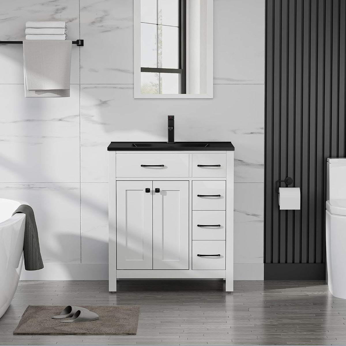Smaller white vanity with a black countertop, single faucet and vertical black wall panel at right.