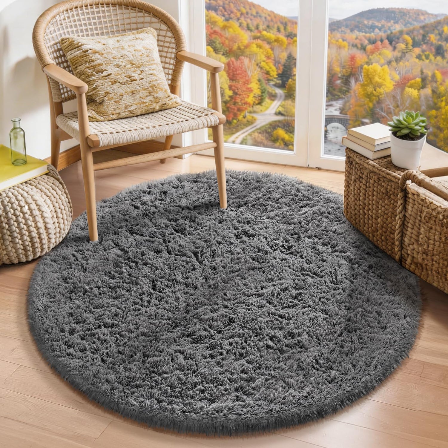 Circular gray fluffy rug under a woven chair and window with autumn landscape outside