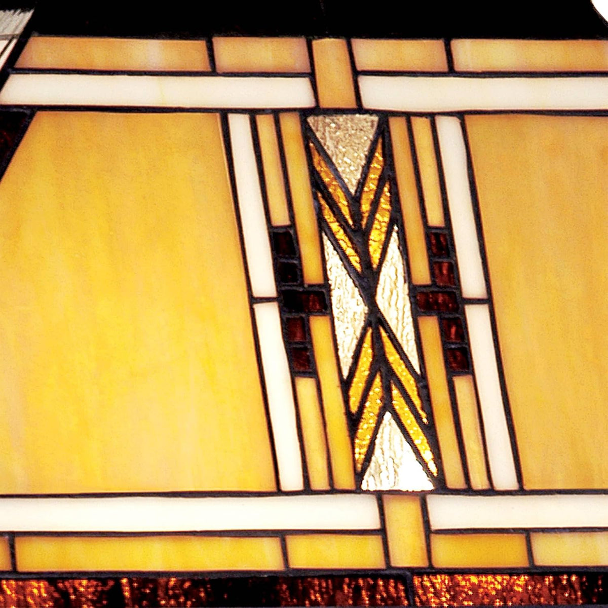 Close-up detail of earth-tone Tiffany-style stained glass panel with geometric leaded design
