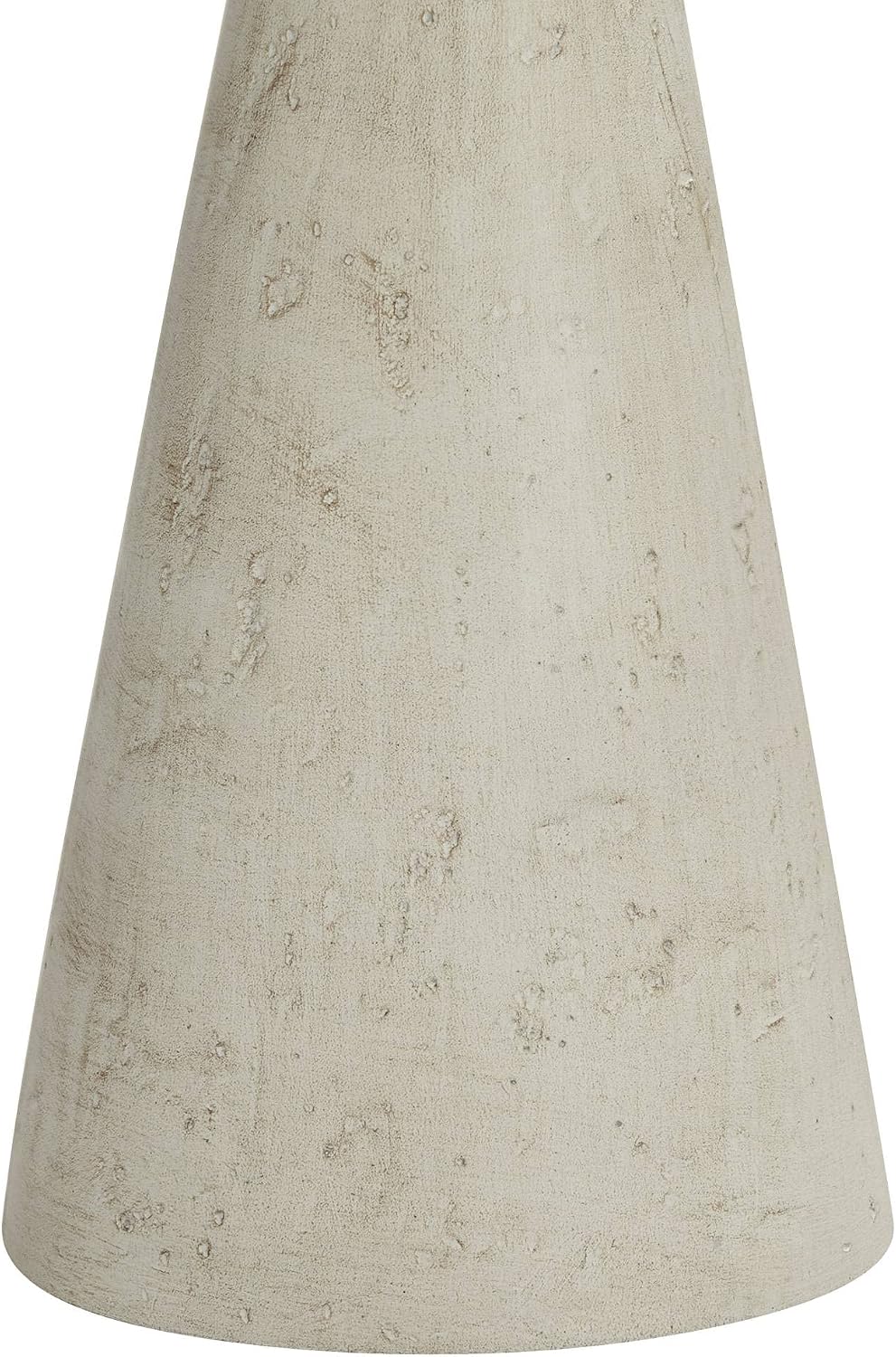 Extreme close-up of the lamp's tapered grey base showing pitted, sandy surface texture