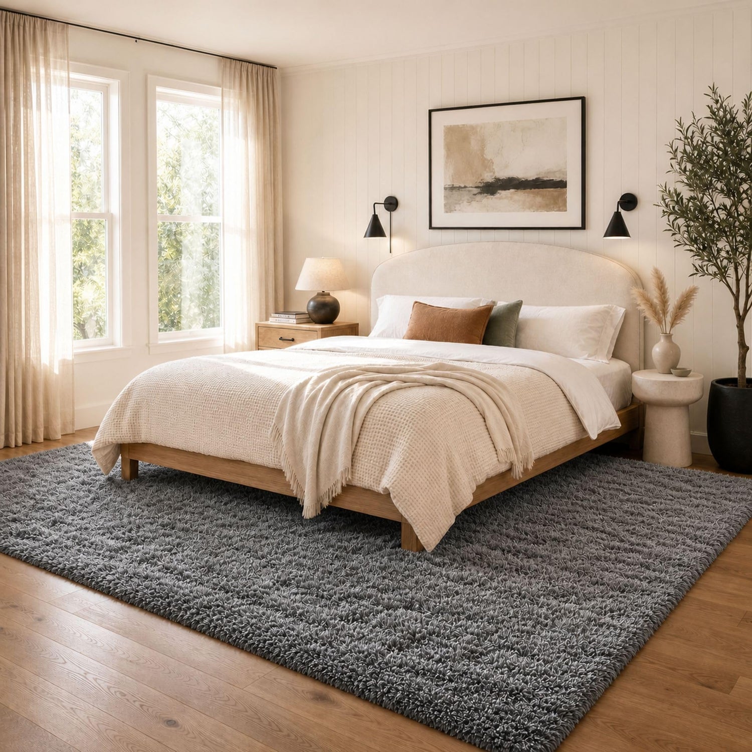 Bedroom with a wooden platform bed, neutral bedding and a textured gray shag rug underfoot