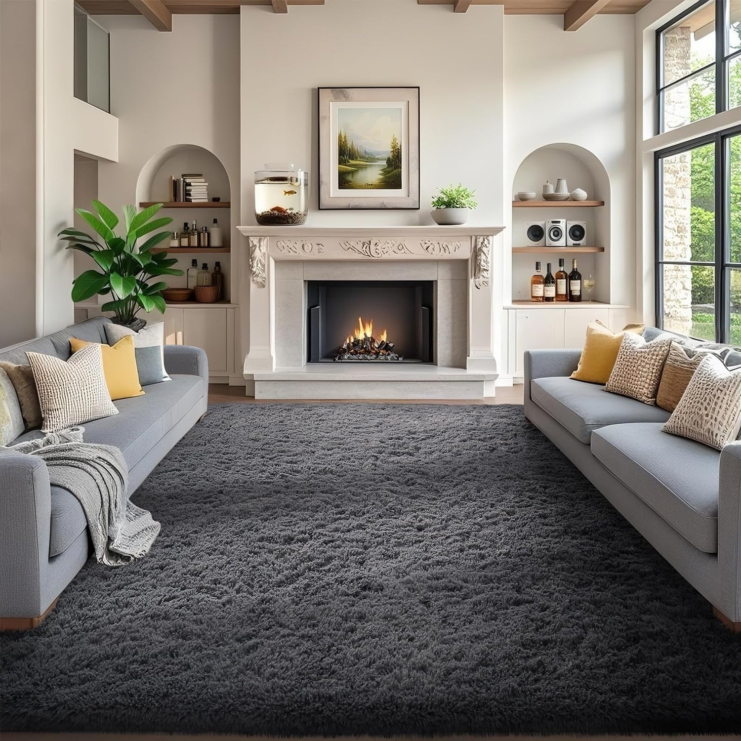 Front view of a living room with a lit fireplace, two gray sofas and a dark gray shag rug