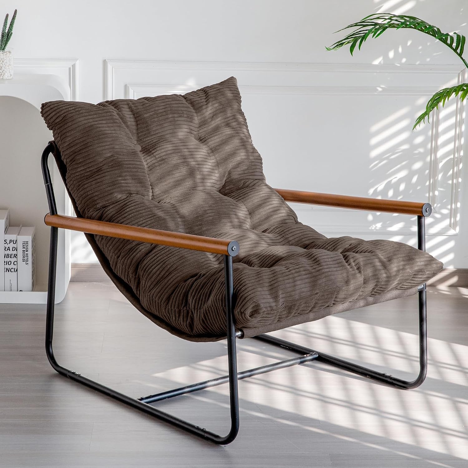 Three-quarter view of a brown corded cushion chair with black metal frame and wooden armrests
