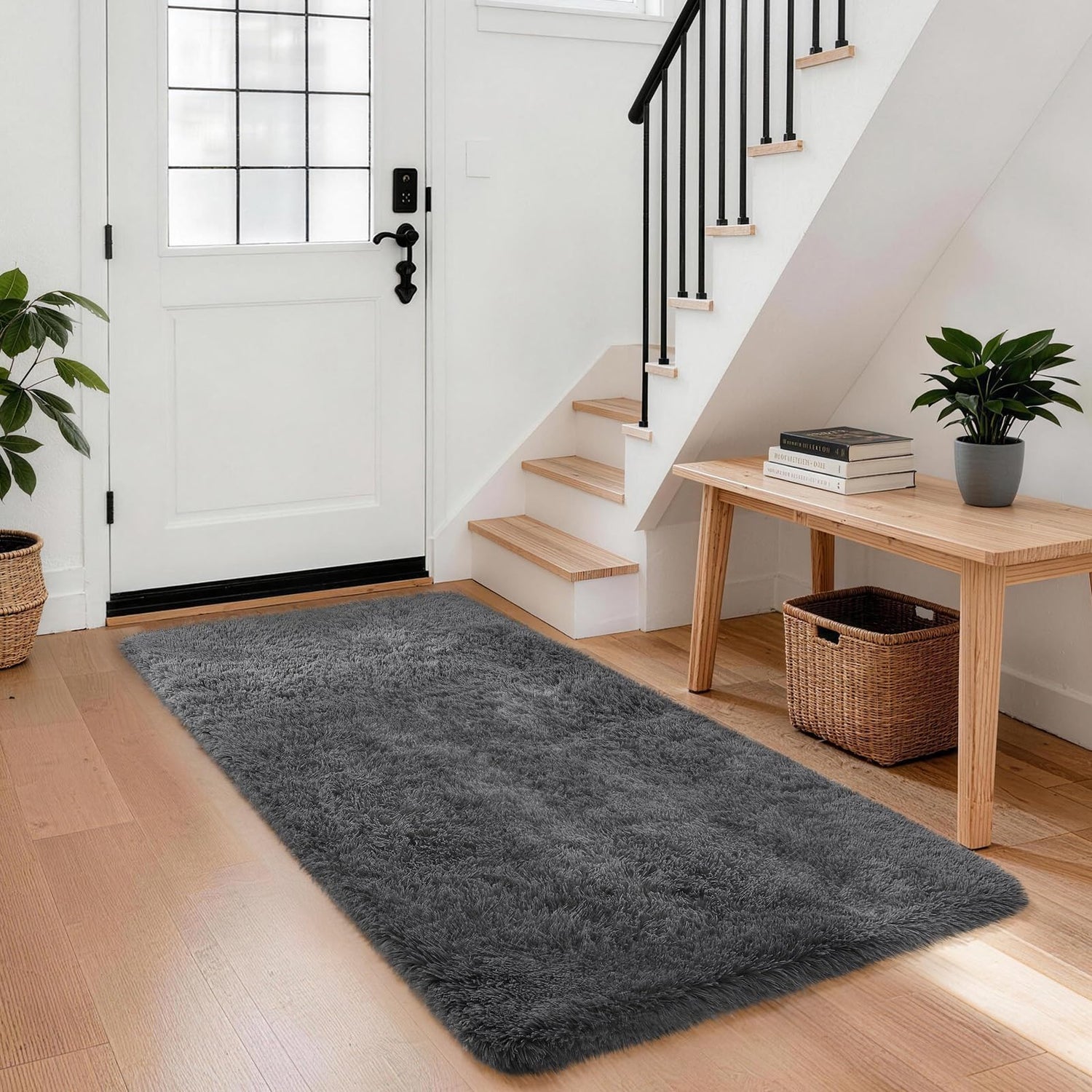 Rectangular gray shag rug placed by a white door next to a wooden bench and basket