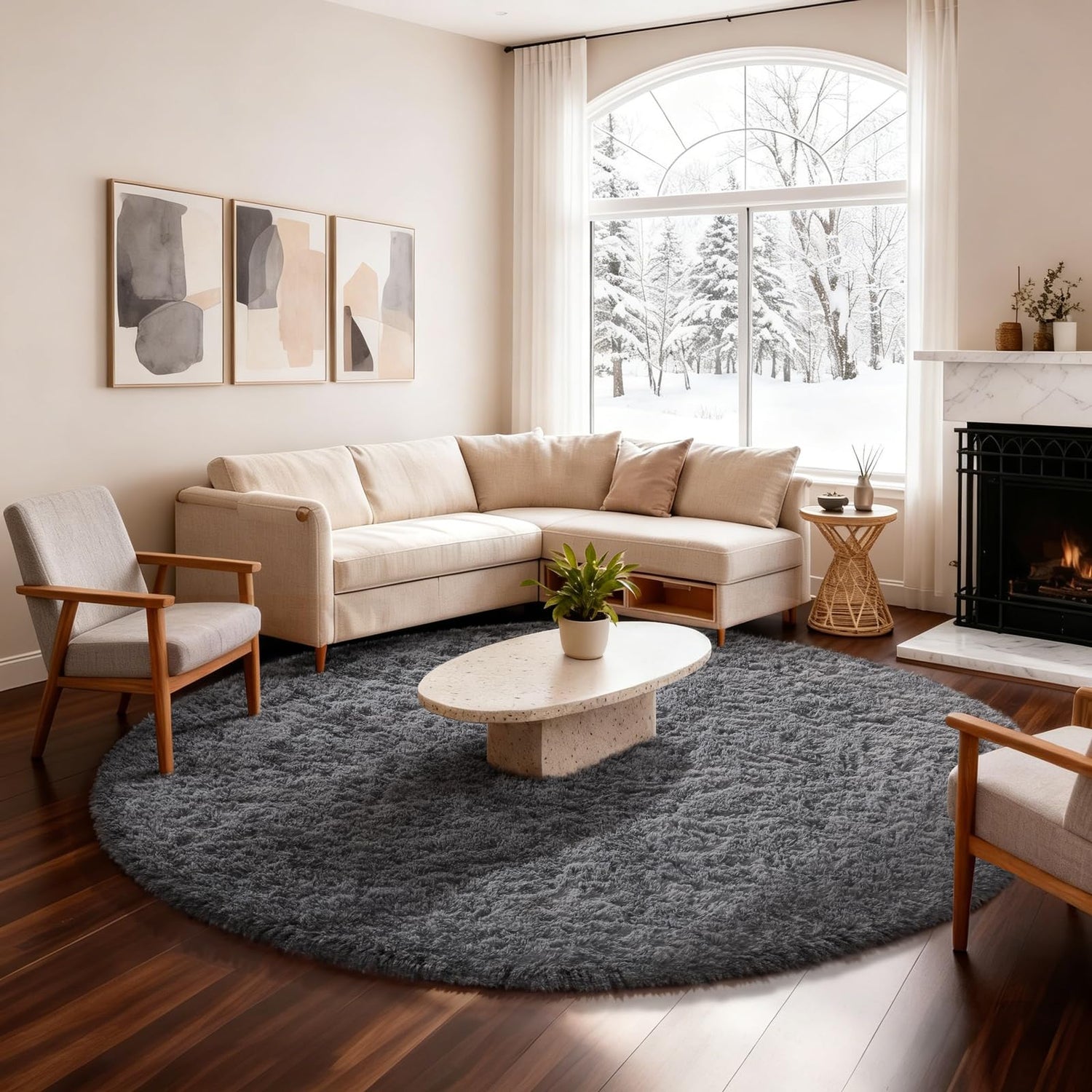 Living room with cream sectional and round dark gray shag rug beneath an oval coffee table.