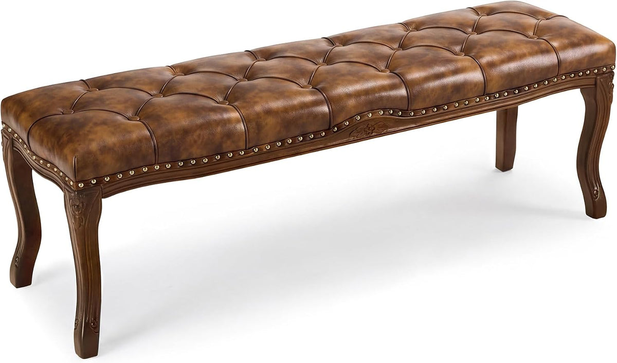 Angled full-length view of an amber-brown tufted bench showing the curving seat profile and legs.